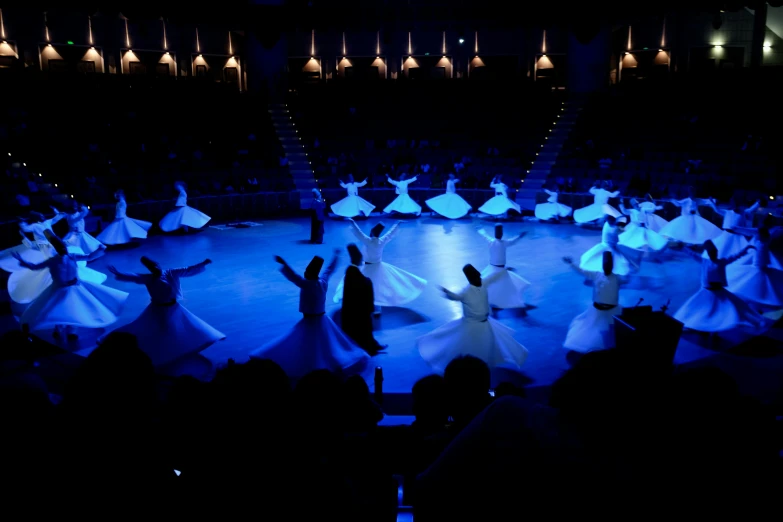 the people on the stage are watching some dancing