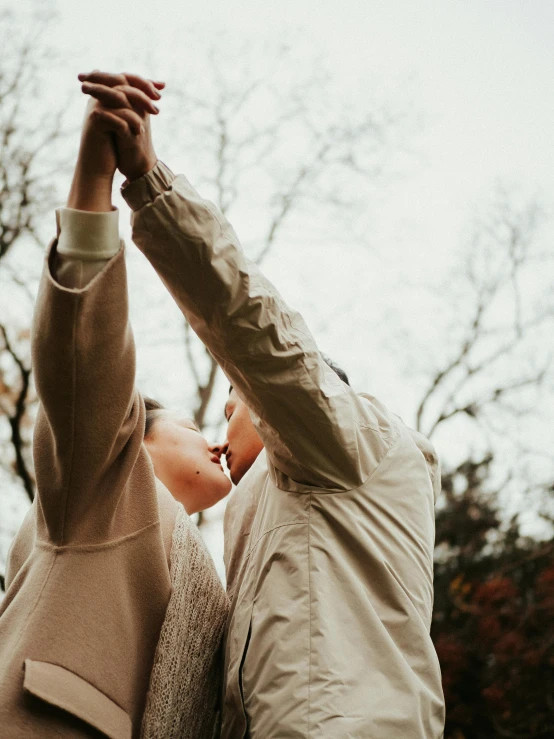 a man and woman are looking into the sky