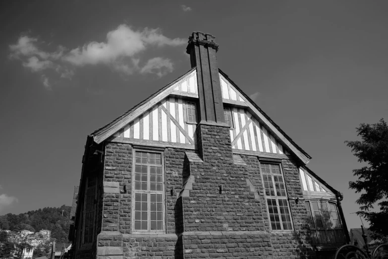 a building with windows and a chimney near trees