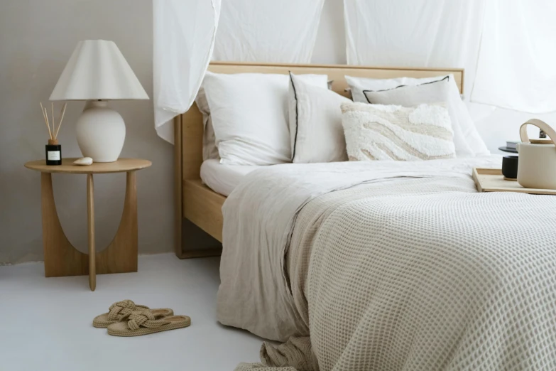 a small white bedroom with a wooden bed and a tall headboard