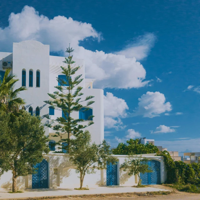 a tall building with blue shutters and many trees