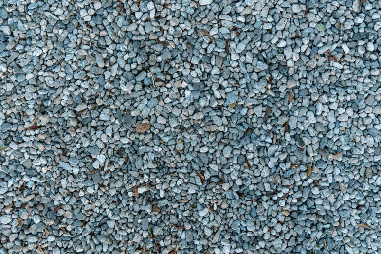 blue and black pebbles cover a building wall