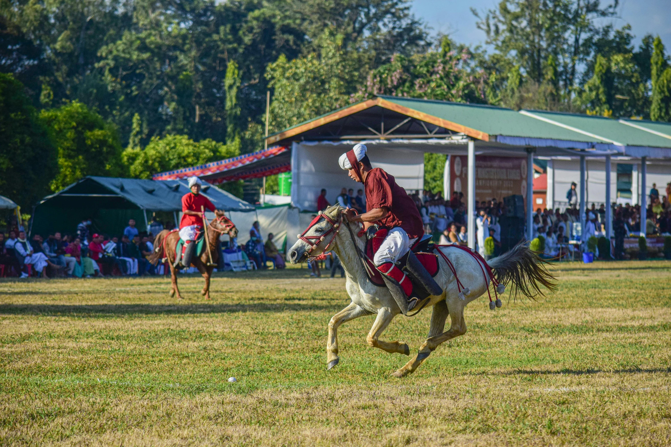 a person in uniform riding on the back of a horse