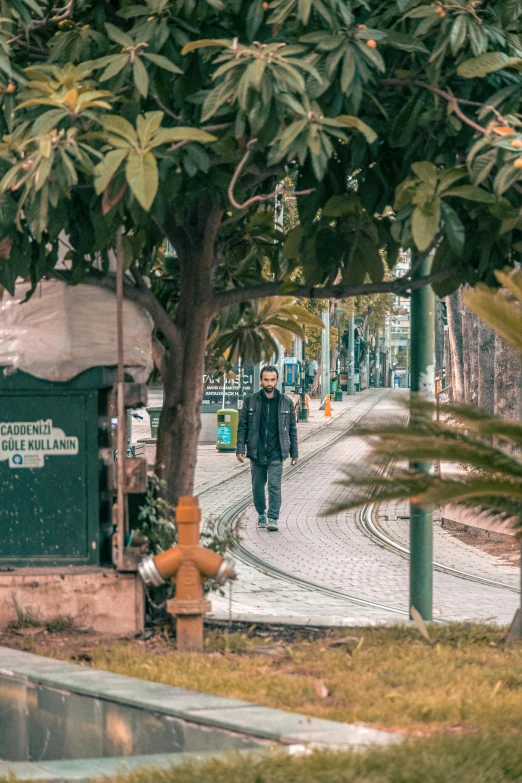 a man walking down the road during the day