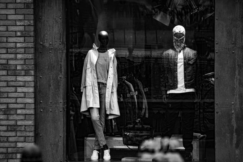 a black and white po of mannequins wearing different types of clothes