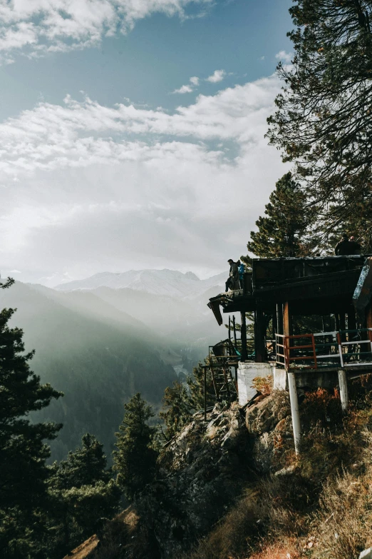 the view from a lookout overlooking a valley, mountains and trees