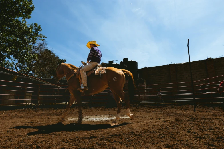 the woman is riding her horse in the corral