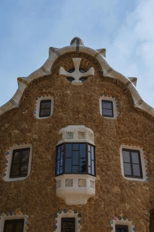 a very tall brown building with windows and an artistic look