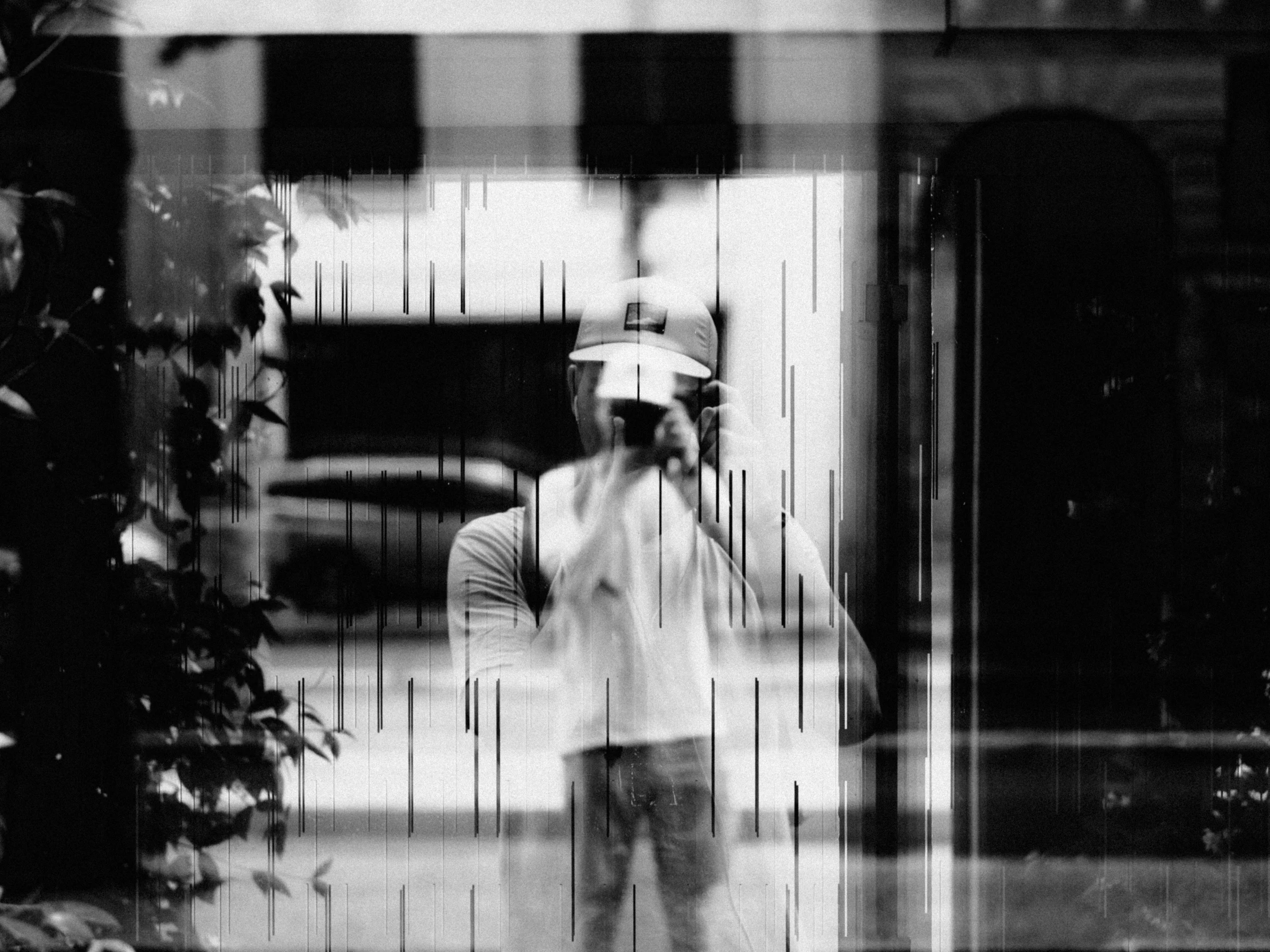 man walking in the rain with an umbrella