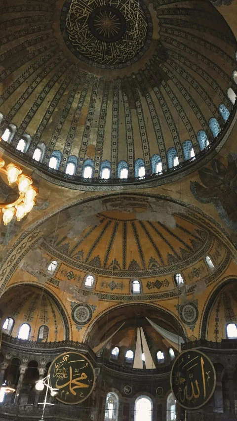 the ceiling and chandelier of an ornate building with intricate ceiling tile