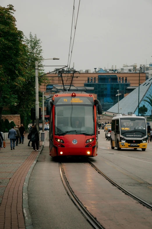 a train in a city pulling up to passengers