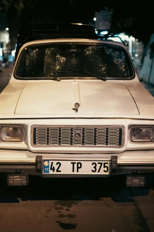 a white sports utility vehicle sitting on the side of a road