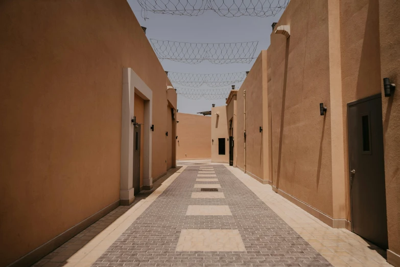 there is a hallway of small houses with brown walls and tile