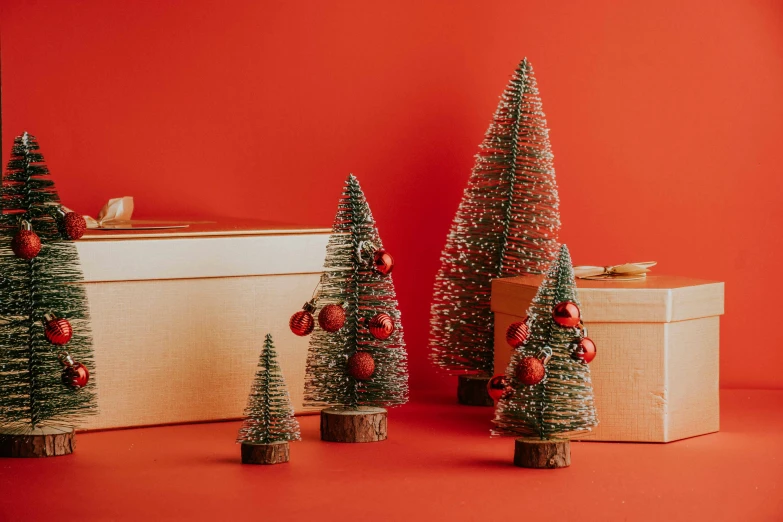 three small christmas trees sitting on top of a table