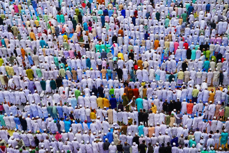 a crowd of people stand in rows with white ones