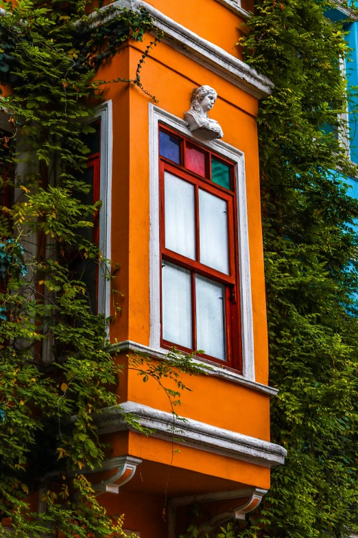 an orange building that has some plants on it