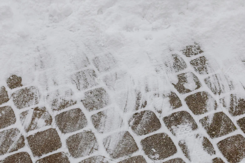 waves are hitting on the ground behind a stone bench