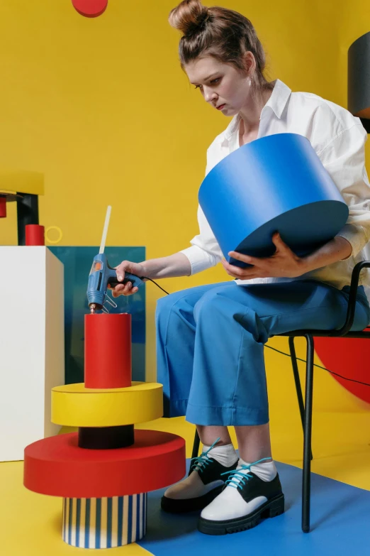 a woman sitting in a chair with colorful blocks and pieces