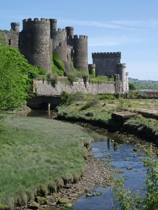 an image of castle like building next to stream