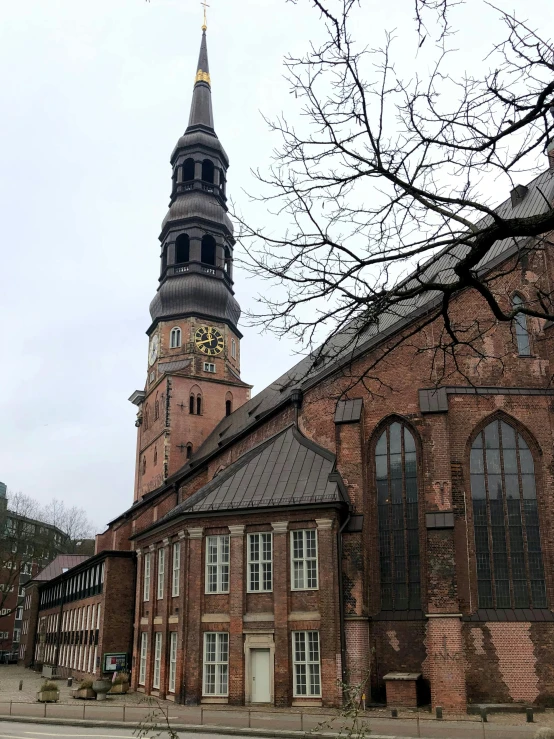 an old church has a clock tower with a spire