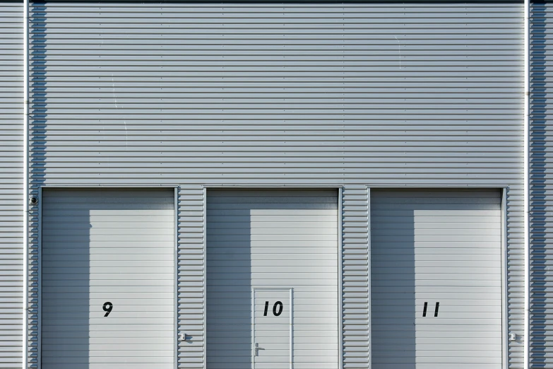 the two identical garage doors are on the outside of this building