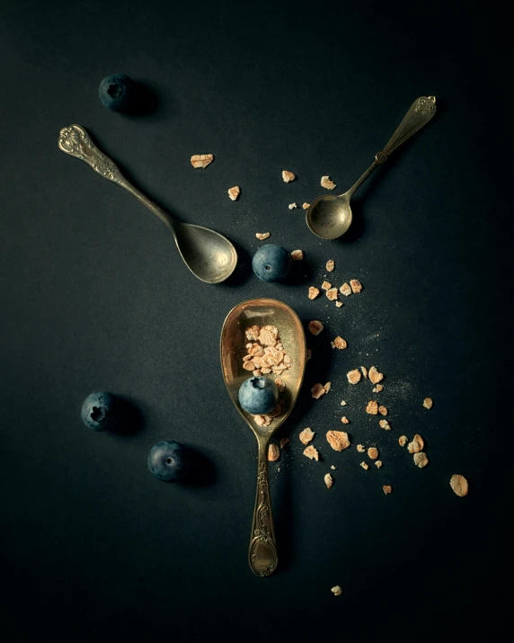 a bowl filled with cereal, blueberries and a spoon full of yogurt