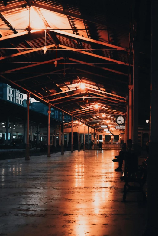 a subway station with lots of benches at night