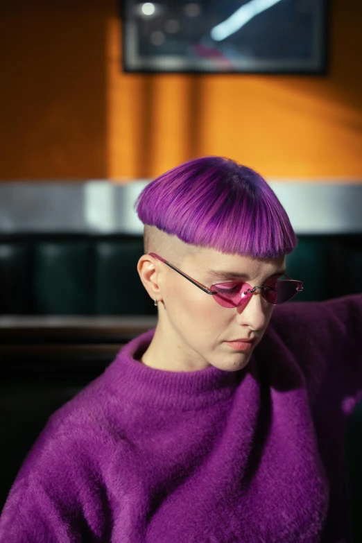 a young woman with pink hair wearing glasses