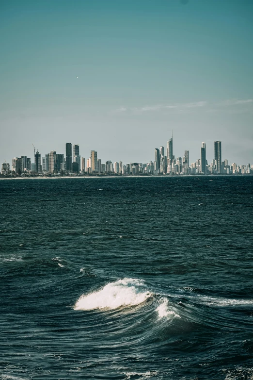 a view of the city skyline and ocean, looking across to an island