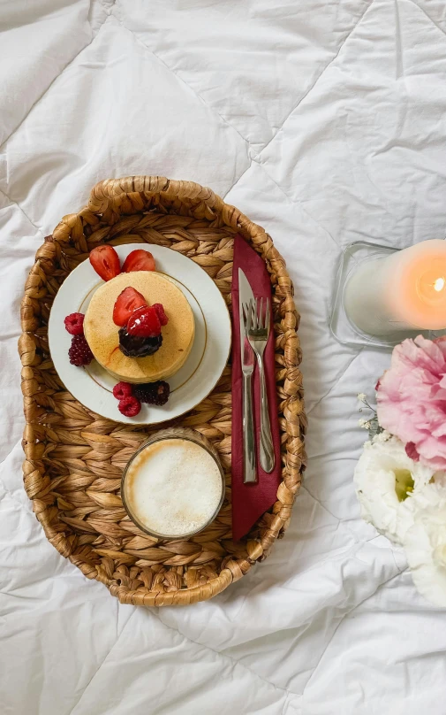 a tray of food sitting on top of a bed