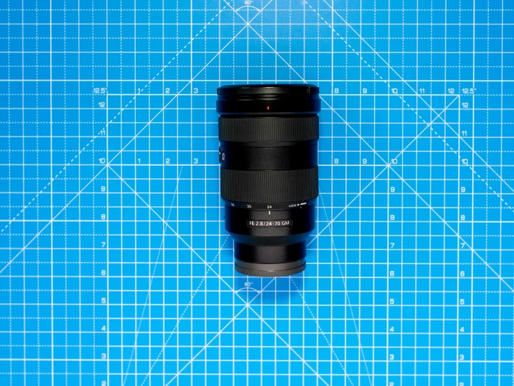 a camera lens sitting next to a blue  mat