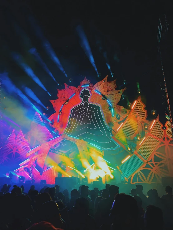 colorful light show with giant buddha statue on stage