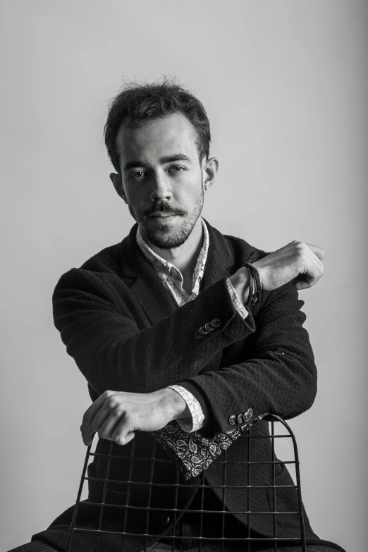 a man leaning on top of a wire basket