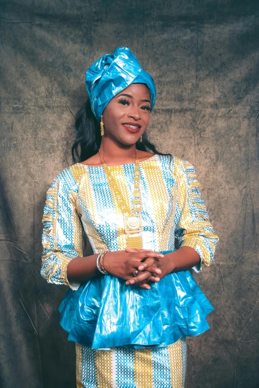 a woman wearing a blue head scarf with a yellow top