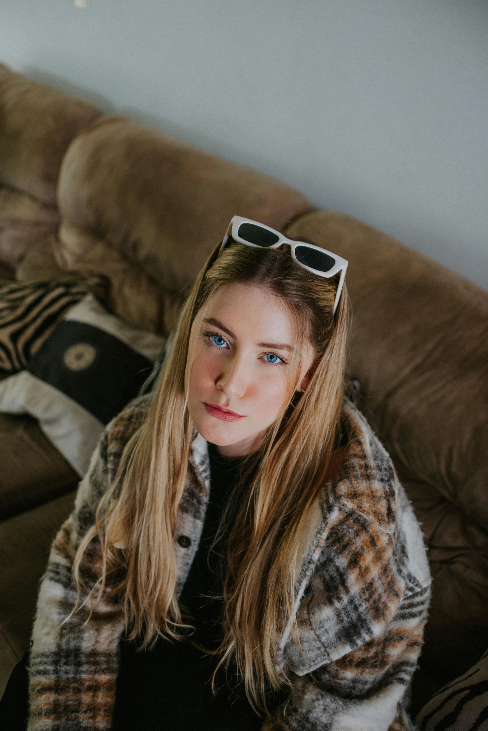 a young lady in a blanket on a couch