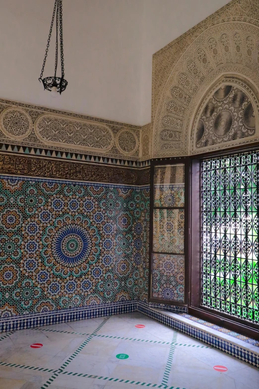 an ornate tiled room with some windows