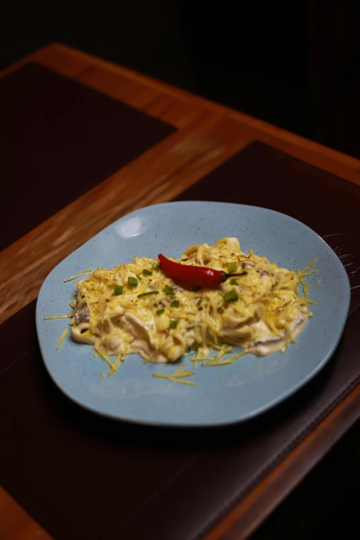 a plate of food on a table with an empty red pepper