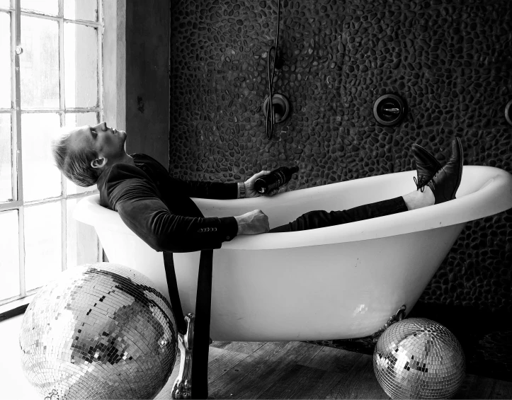 a man laying in the bathtub of his home