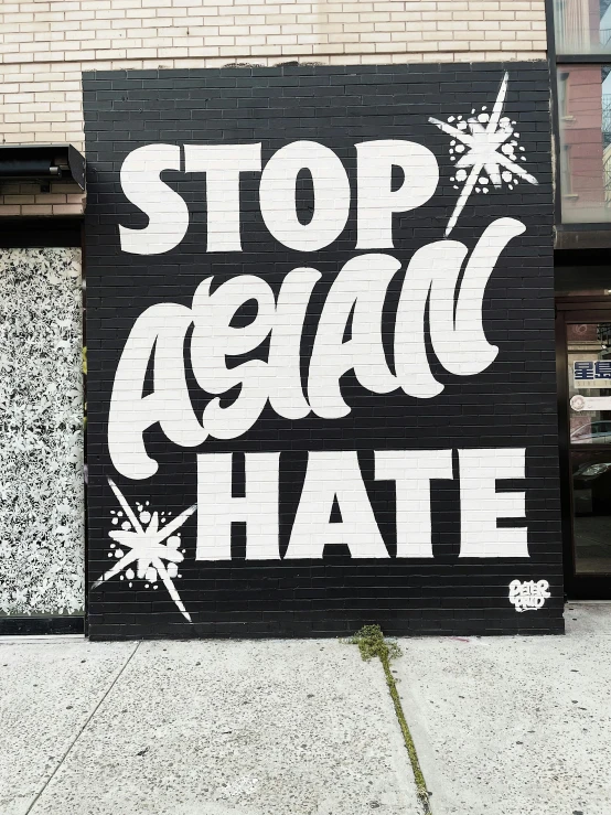 a large black and white sign is next to a building