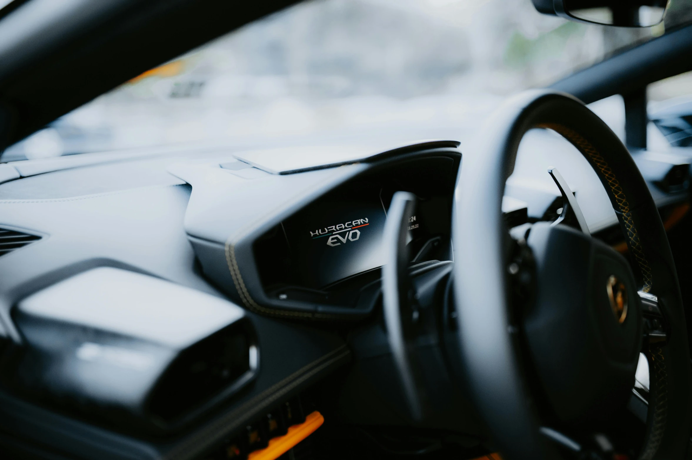 a dashboard of a modern looking car on a city street