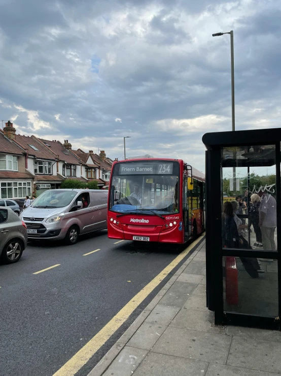 cars, bus, and van waiting at the bus stop