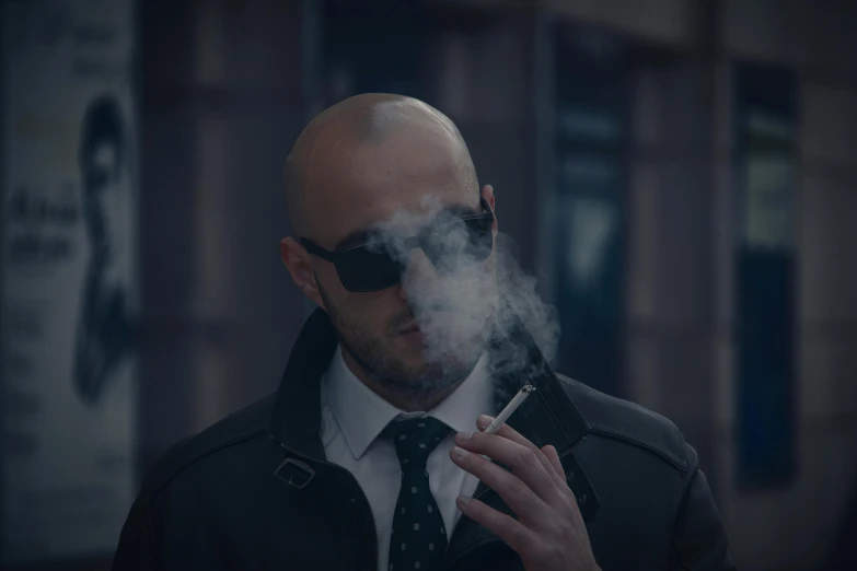 a man wearing sunglasses and smoking a cigarette