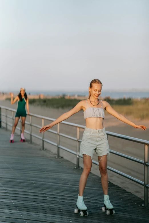 a girl rollerblading on a boardwalk near other girls