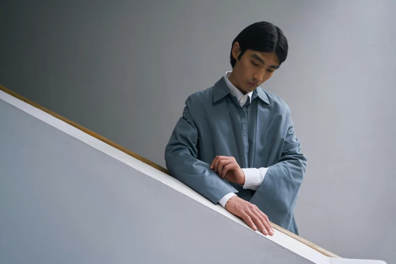 the young man is standing on a set of stairs