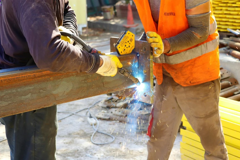 a man welderging through metal with some sparks