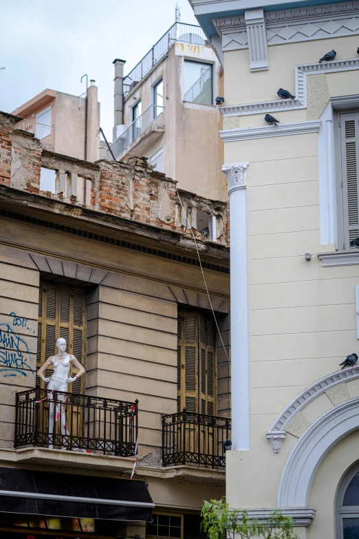 a building that has some windows and balcony with people on the top of it