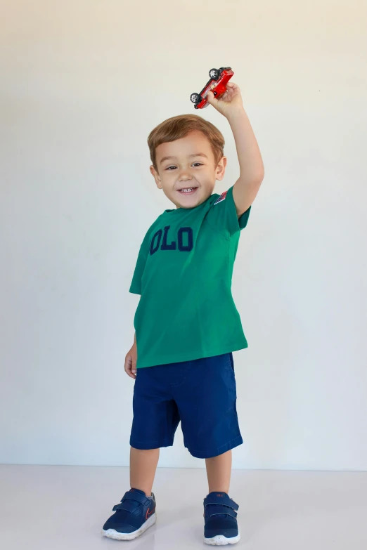 a child holding up a toy in the air