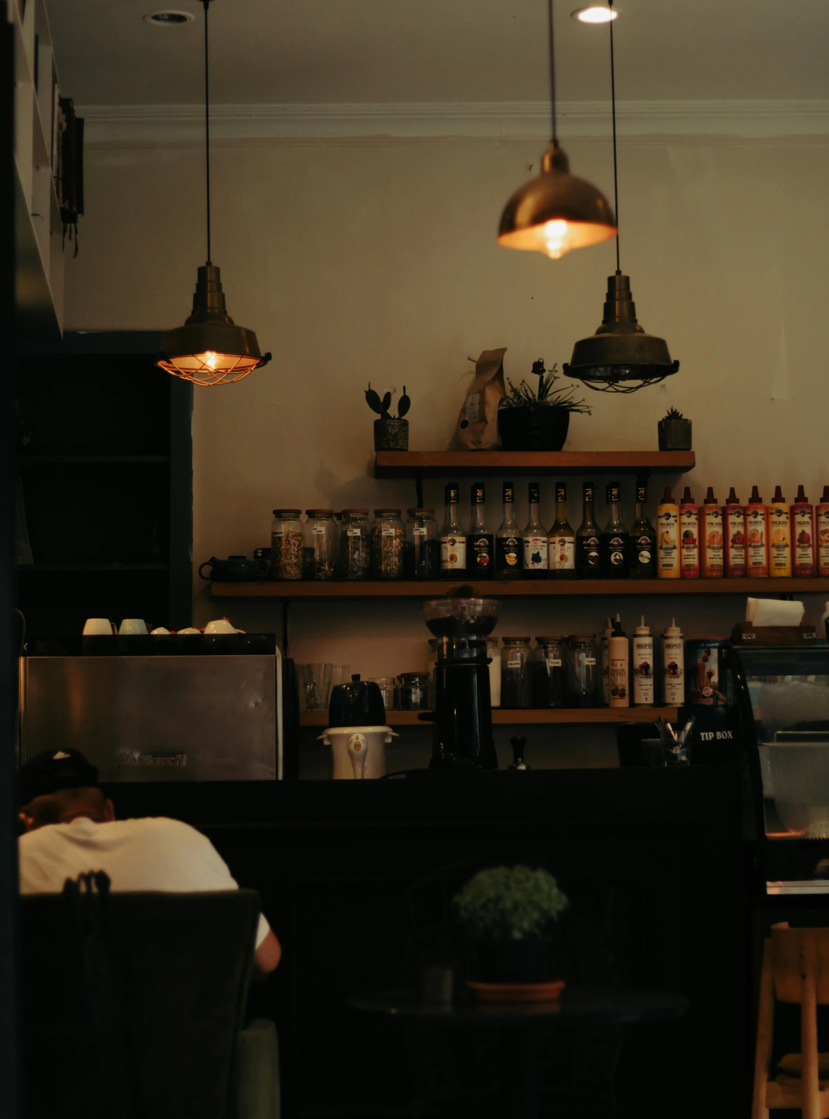 the counter of a restaurant with a number of beer bottles