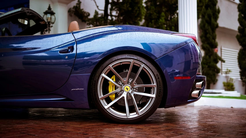 a sports car with its door open on a brick road