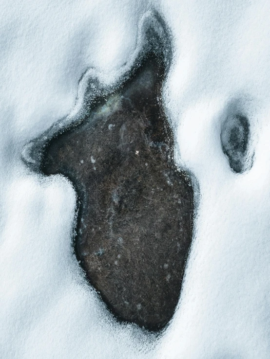 a snow covered area with a circle and footprints